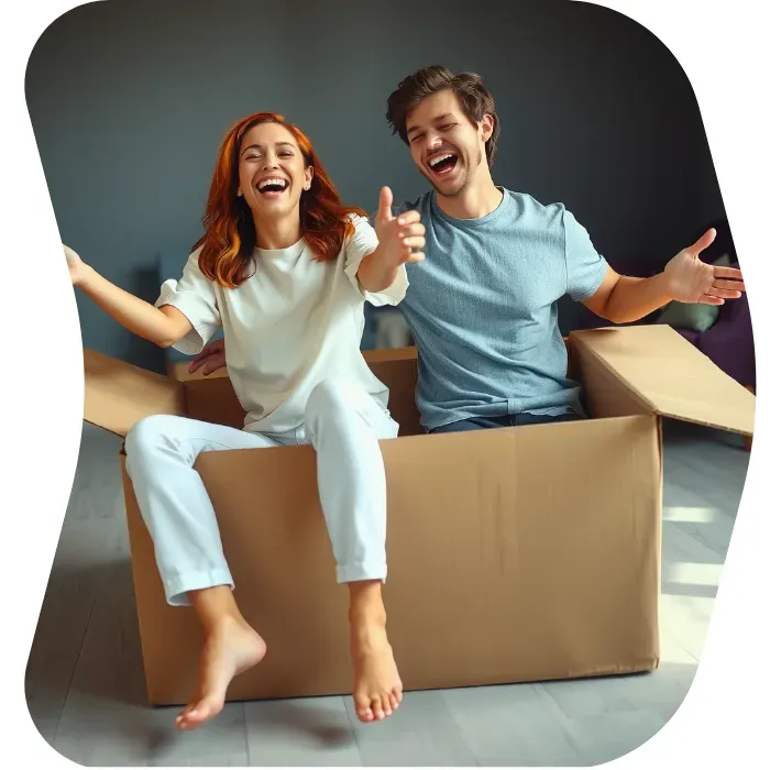 Two guys sitting on the floor of their apartment with Muval moving boxes